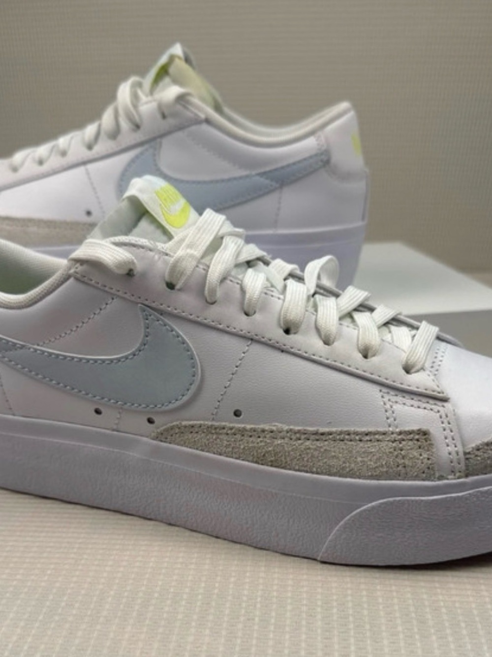 Nike Women’s White Low-Top Sneakers with Light Blue Swoosh and Pale Yellow Logo